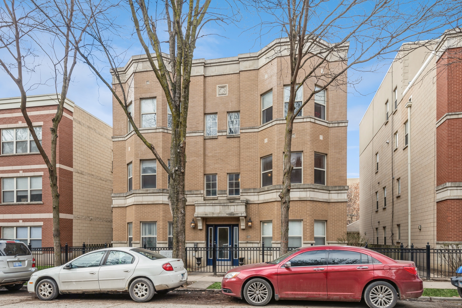 a front view of a building with parking space