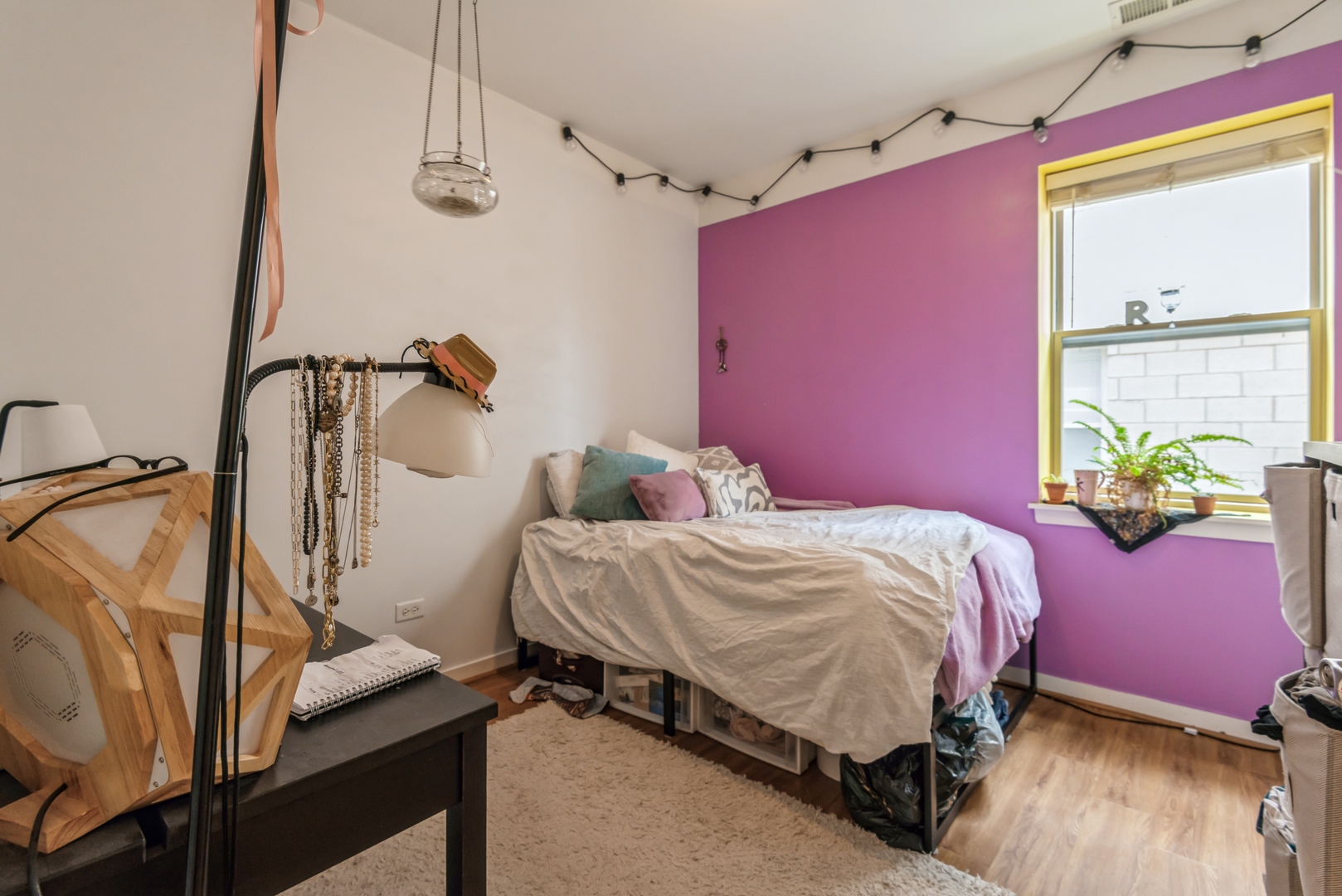 1022 South Racine Avenue, Unit 201 Chicago, IL 60607 - Photo 11 of 13 a bed sitting in a bedroom next to a window