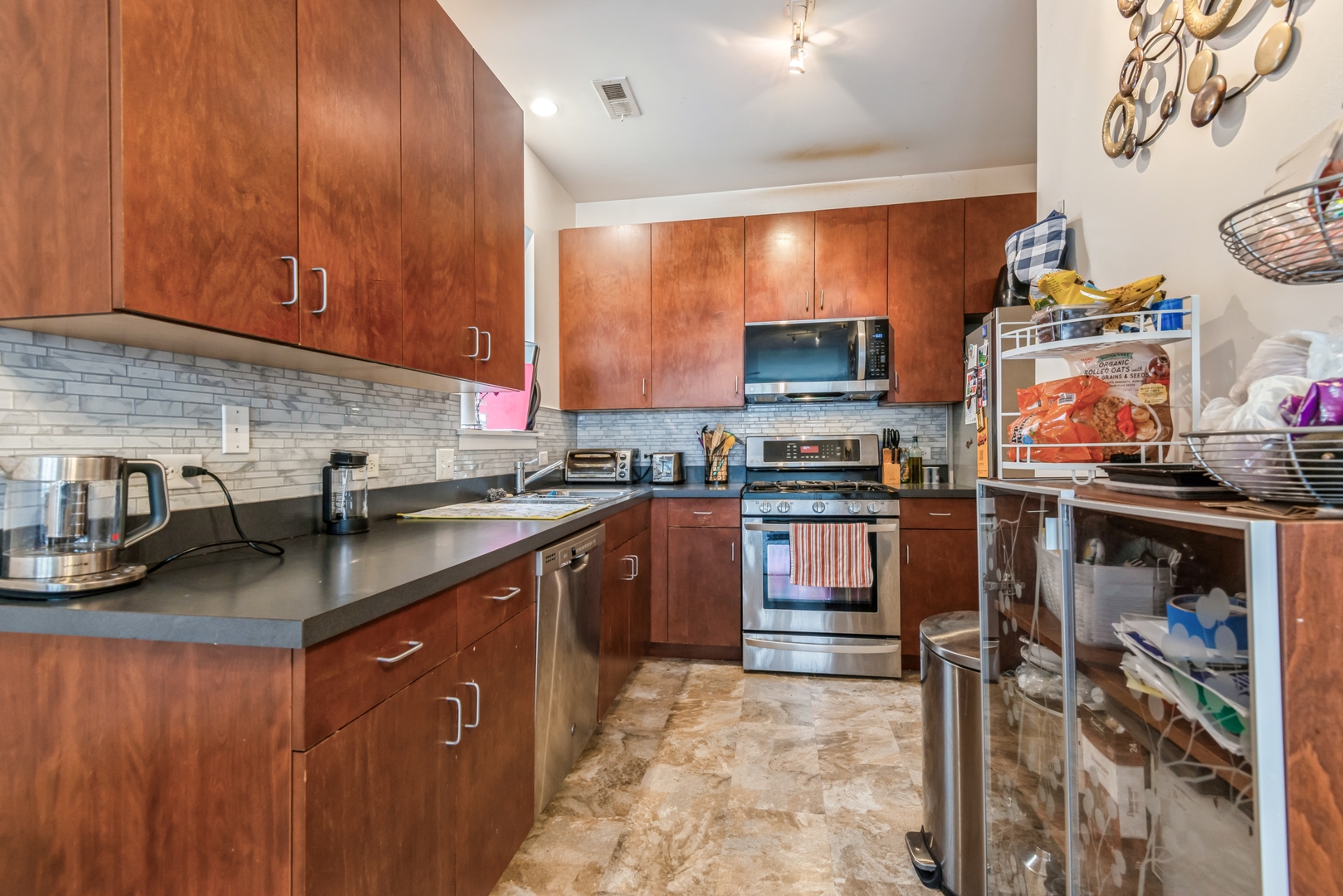 1022 South Racine Avenue, Unit 201 Chicago, IL 60607 - Photo 4 of 13 a kitchen with stainless steel appliances granite countertop a stove a sink and a microwave