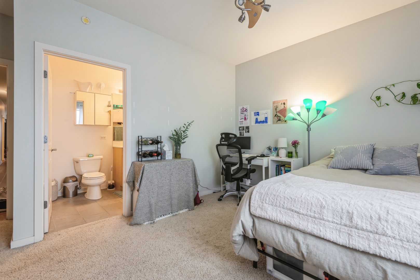 1022 South Racine Avenue, Unit 201 Chicago, IL 60607 - Photo 8 of 13 a bedroom with bed and a chair