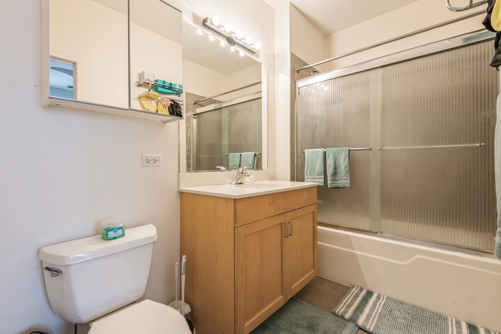 1022 South Racine Avenue, Unit 201 Chicago, IL 60607 - Photo 9 of 13 a bathroom with a sink mirror vanity and toilet