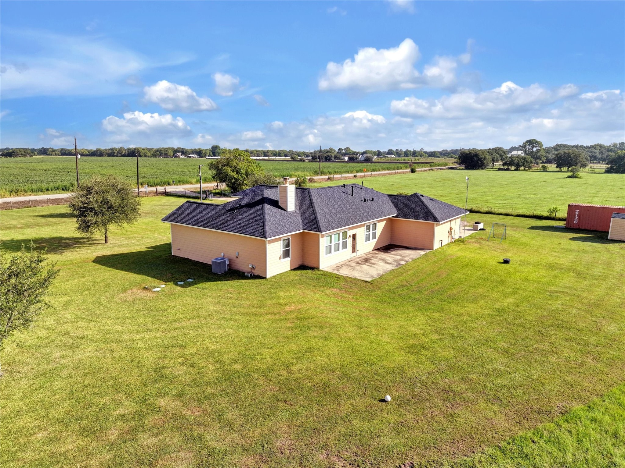 8131 Brinkmeyer Road Needville, TX 77461 - Photo 8 of 49 Charming single-story home set on a spacious plot of lush green land, offering serene rural views and ample outdoor space for activities and relaxation.