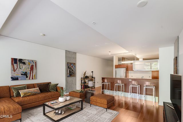 a living room with furniture kitchen view and a table