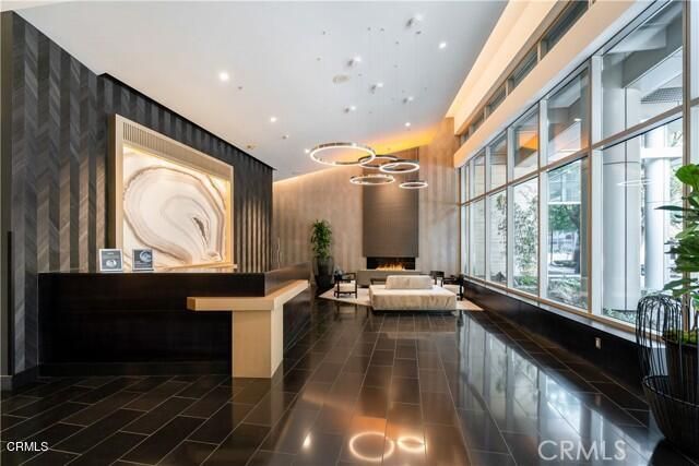 a front view of a building with a garden and plants