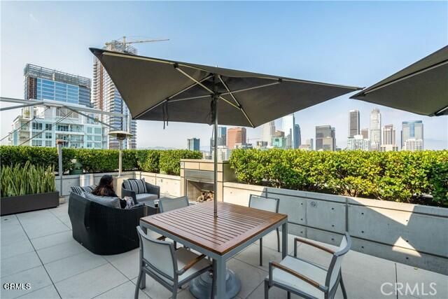 a view of a balcony with furniture and a floor to ceiling window