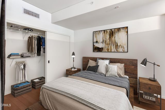 a bedroom with a bed and wooden floor