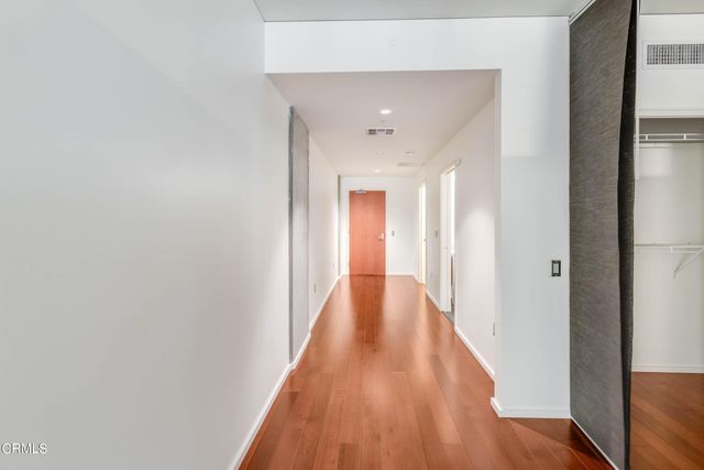 a view of a hallway with wooden floor
