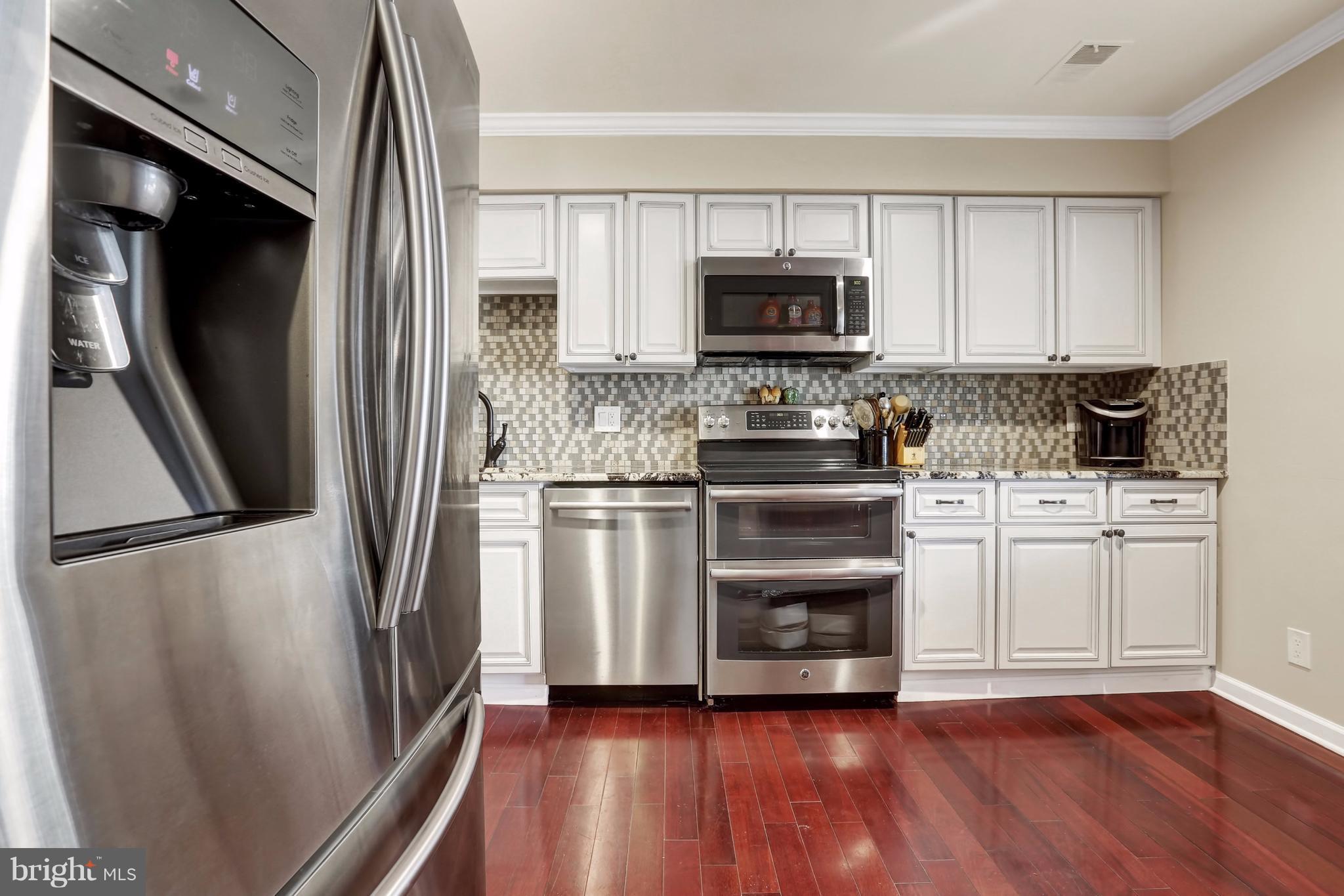 17420 Hoskinson Road Poolesville, MD 20837 - Photo 5 of 28 a kitchen with stainless steel appliances a refrigerator sink and microwave