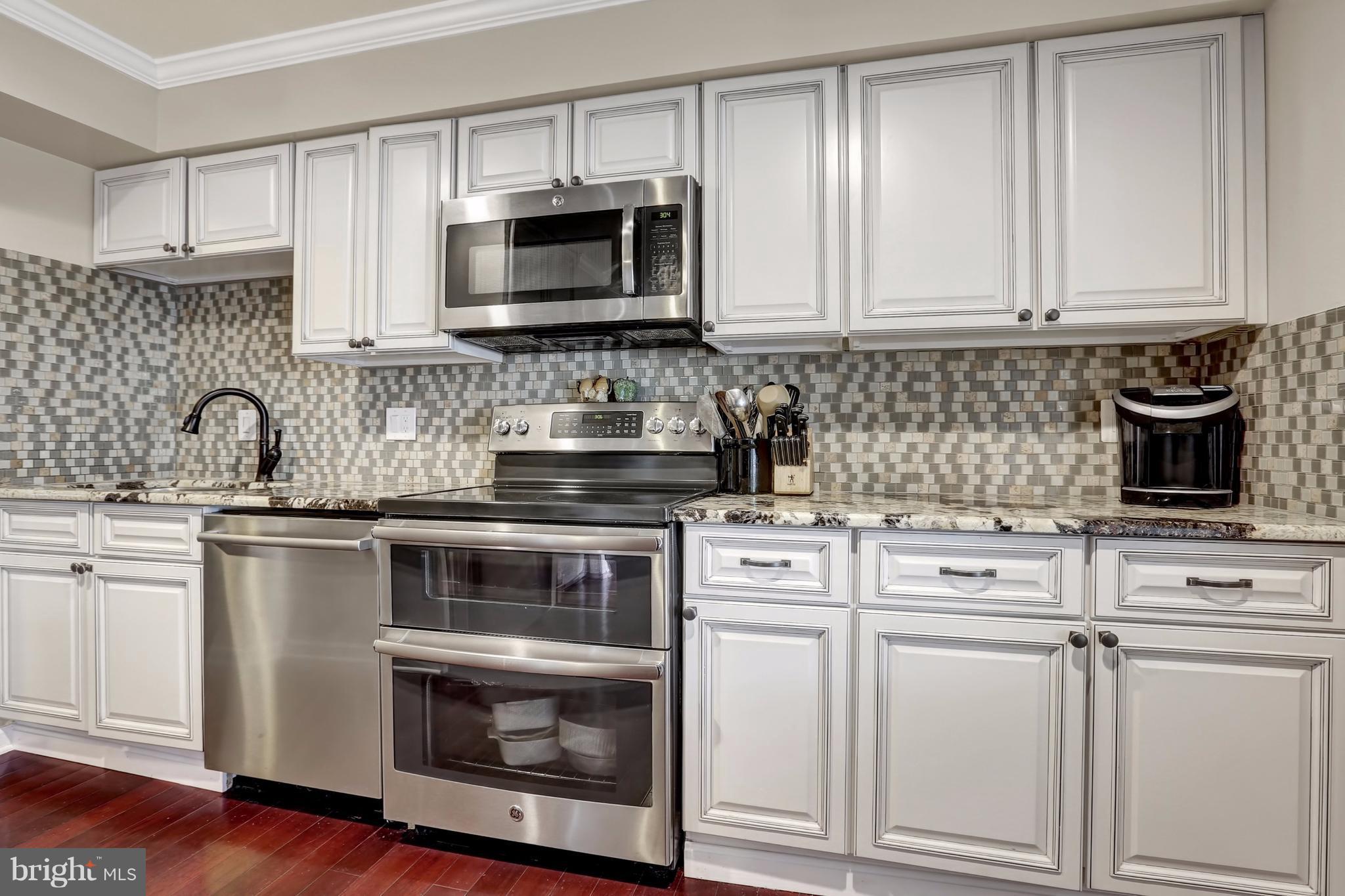 17420 Hoskinson Road Poolesville, MD 20837 - Photo 8 of 28 a kitchen with white cabinets and stainless steel appliances