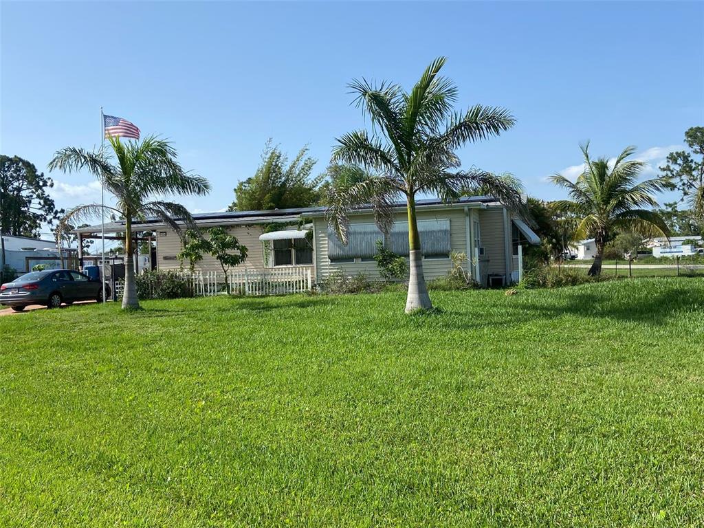 a front view of house with yard and outdoor seating