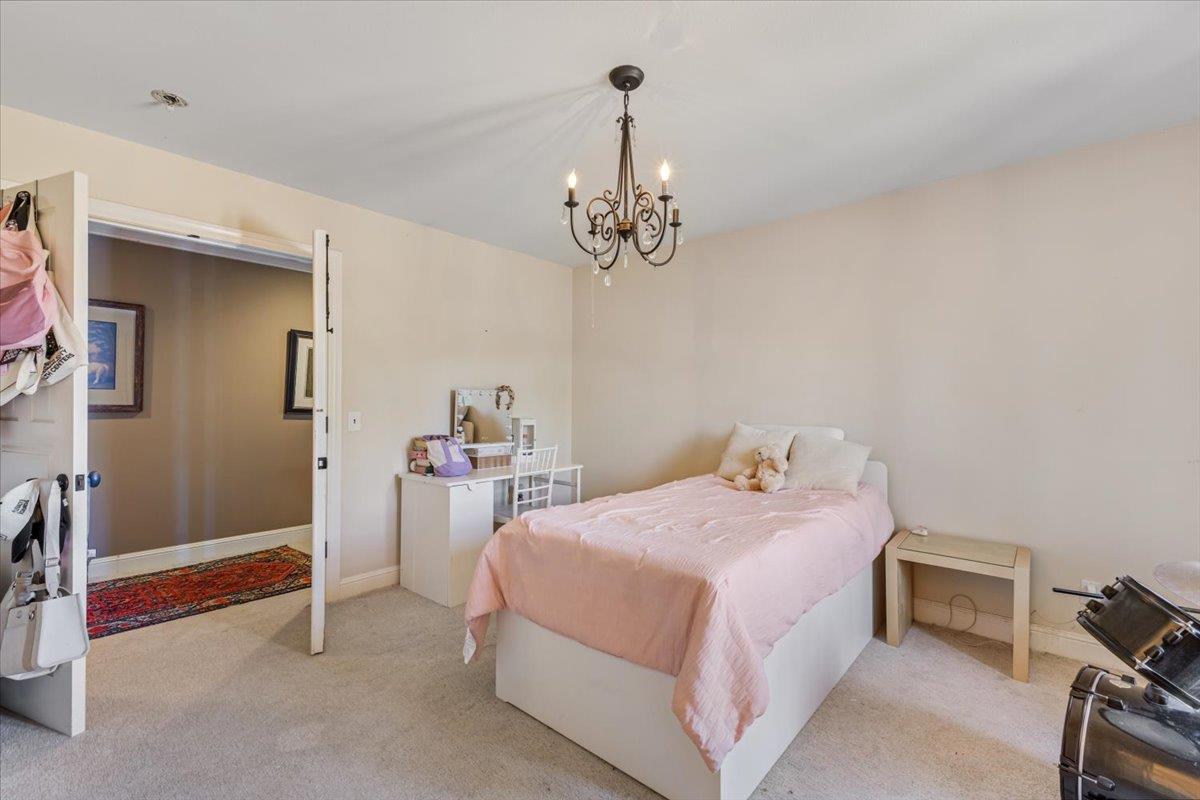 2727 Thomas Road Hollister, CA 95023 - Photo 24 of 83 a bedroom with a bed and a chandelier