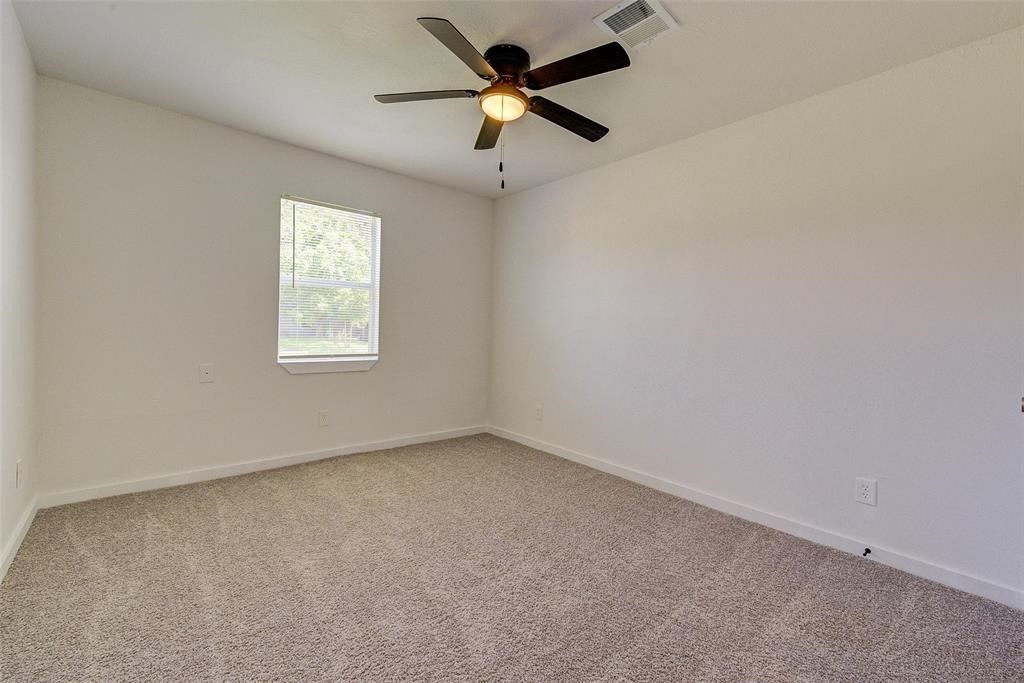 4218 Friar Point Road Houston, TX 77047 - Photo 19 of 26 an empty room with a window and a fan