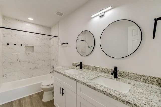 a bathroom with a toilet a sink and a mirror