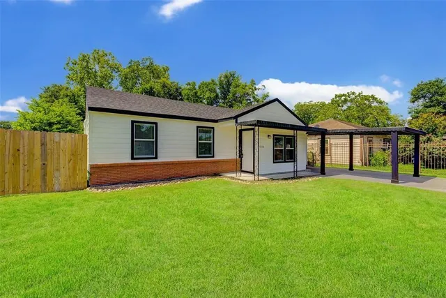 a view of a house with a yard and porch