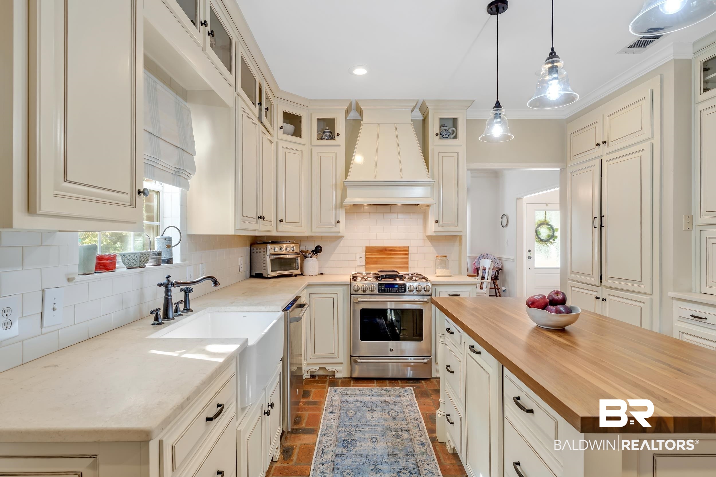 2 Navy Lane Daphne, AL 36527 - Photo 11 of 28 Kitchen featuring wood counters, decorative backsplash, brick floors, appliances with stainless steel finishes, and healthy amount of natural light