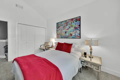 a bedroom with a bed and a lamp