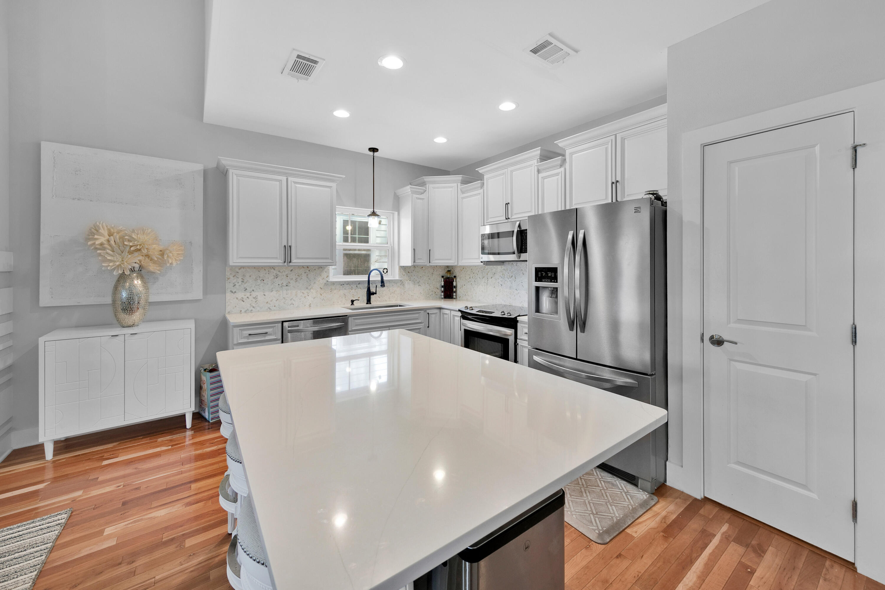 250 Marlberry Trace Santa Rosa Beach, FL 32459 - Photo 7 of 30 a kitchen with stainless steel appliances a refrigerator a stove a sink cabinets and wooden floor