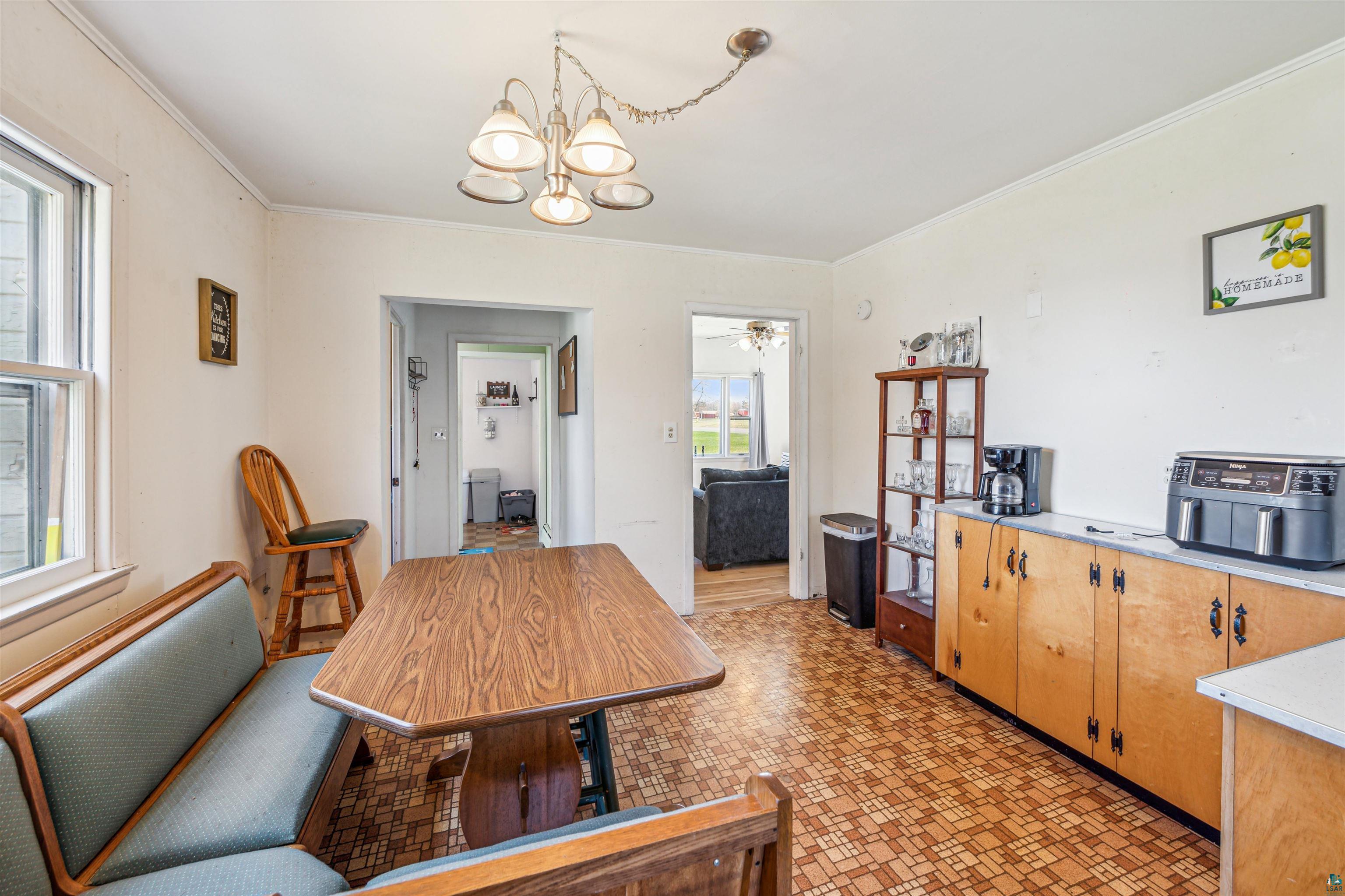 8920 School Road Port Wing, WI 54865 - Photo 14 of 27 Dining space with ornamental molding and a chandelier