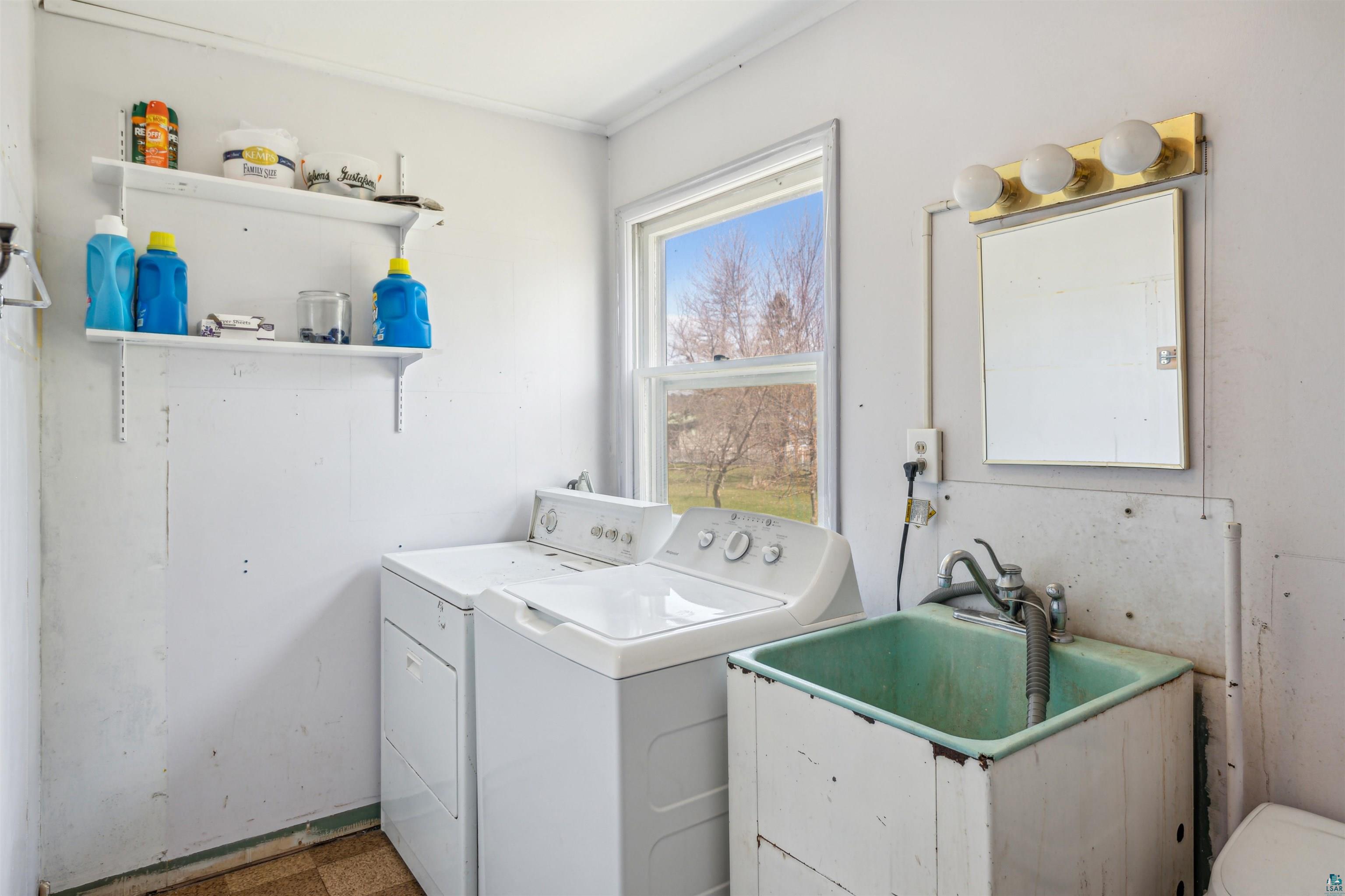 8920 School Road Port Wing, WI 54865 - Photo 17 of 27 Laundry room featuring laundry area, washing machine and dryer, and a sink