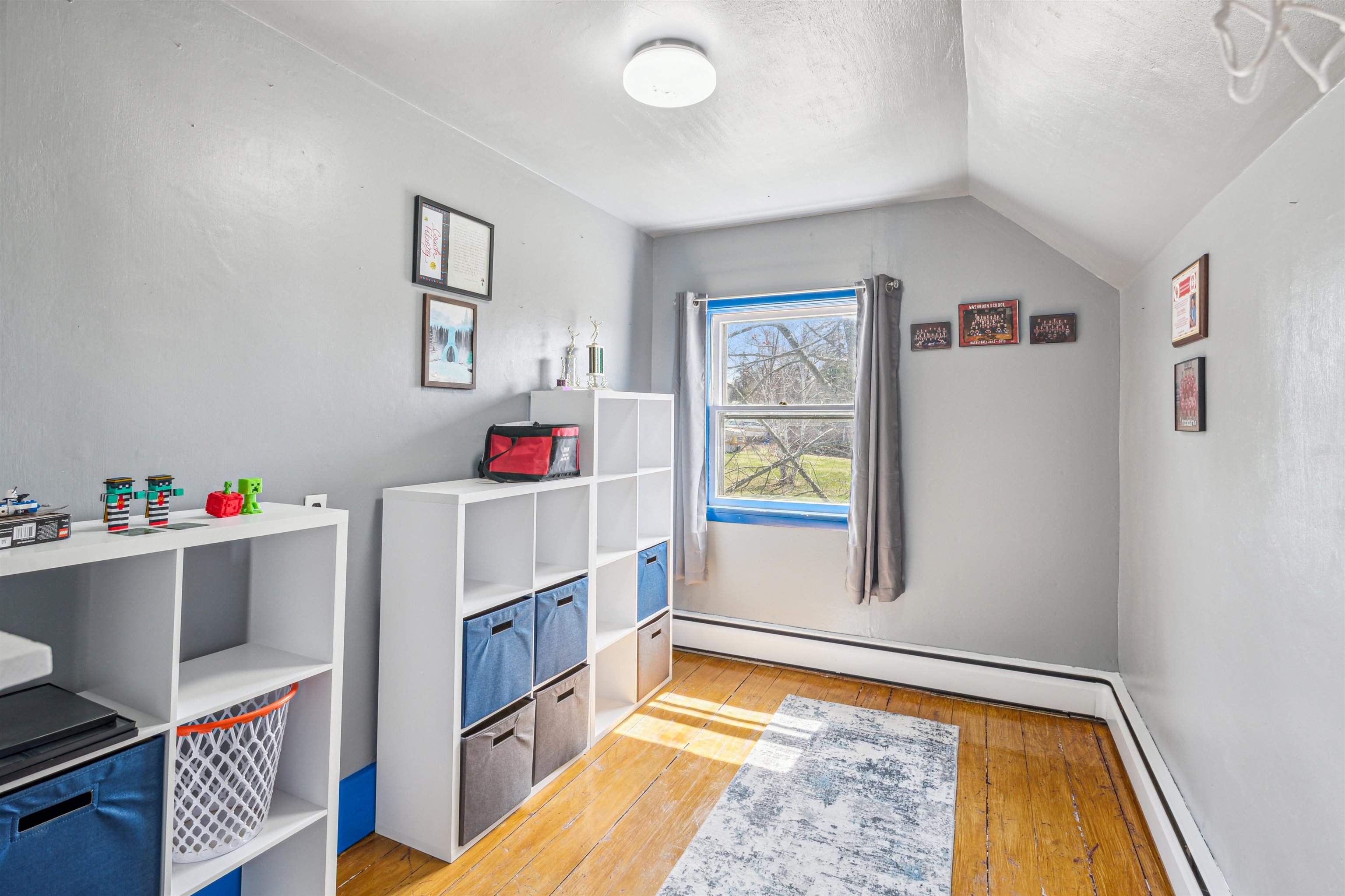8920 School Road Port Wing, WI 54865 - Photo 23 of 27 Recreation room with light wood-style floors, a textured ceiling, vaulted ceiling, and baseboard heating