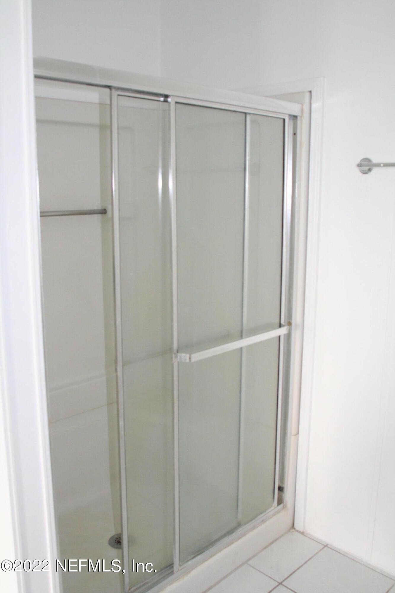 45657 Bismark Road Callahan, FL 32011 - Photo 16 of 21 a bathroom with a glass shower door