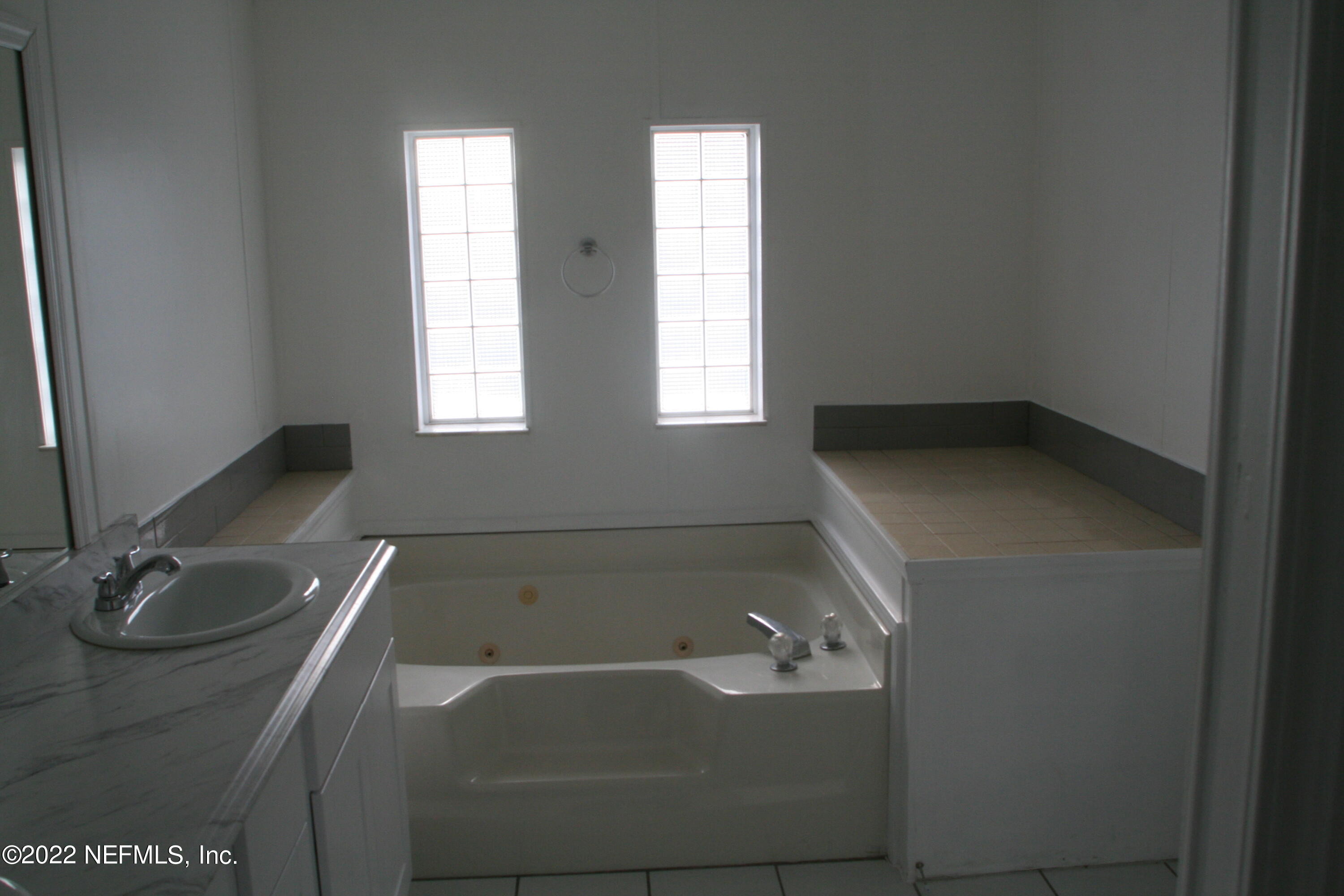 45657 Bismark Road Callahan, FL 32011 - Photo 17 of 21 a bathroom with a tub sink and window