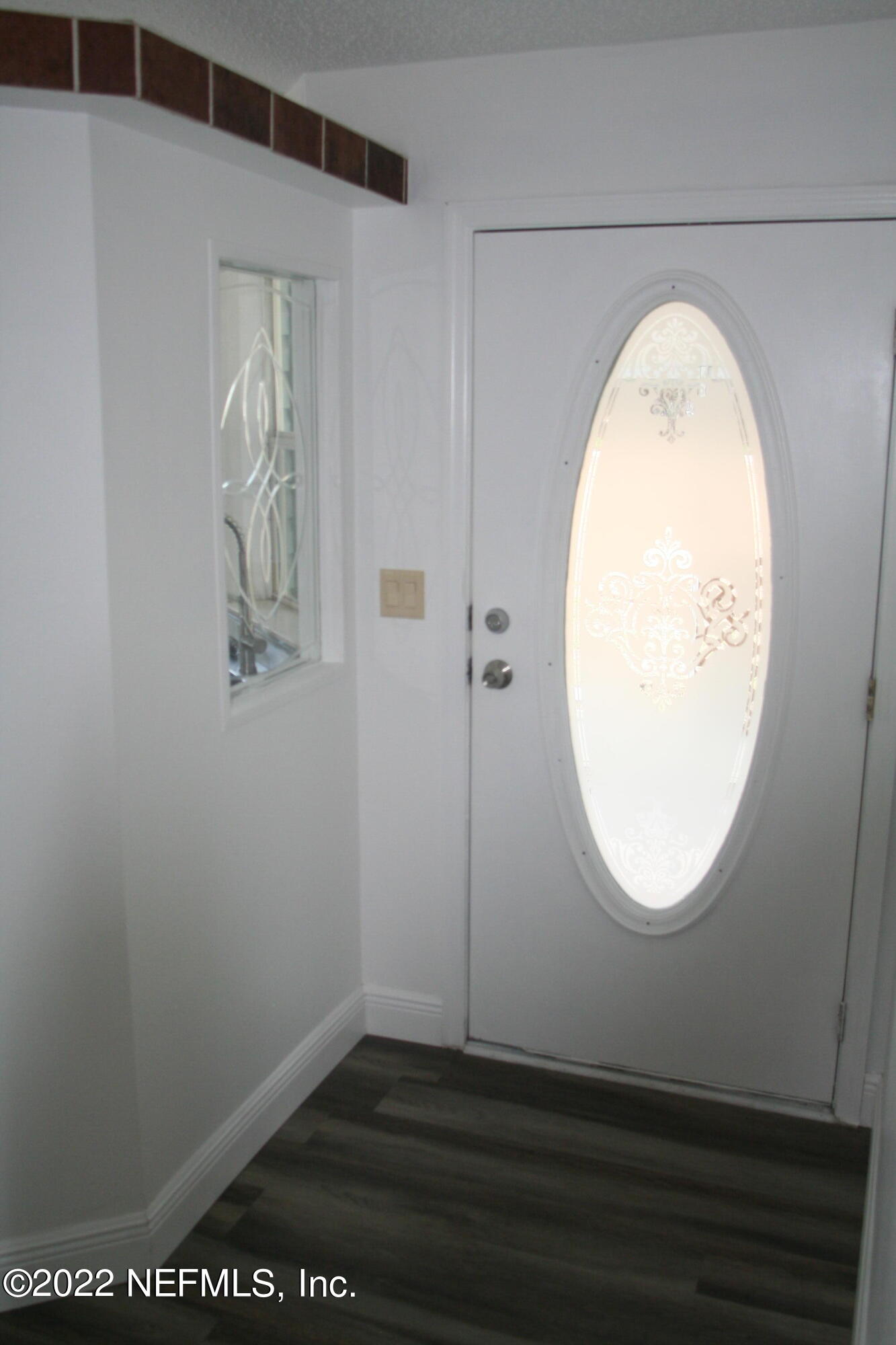 45657 Bismark Road Callahan, FL 32011 - Photo 21 of 21 an empty room with wooden floor and mirror