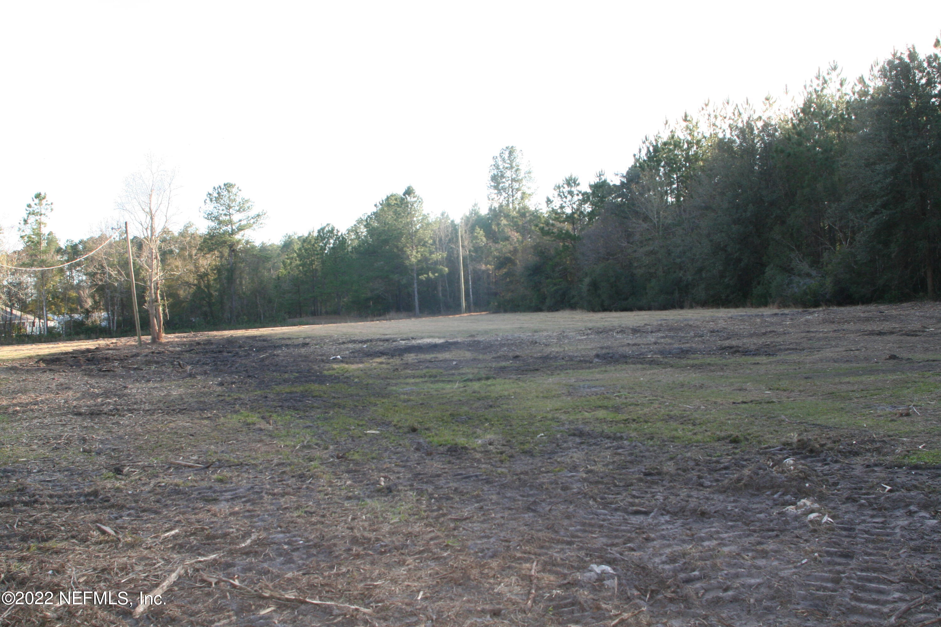 45657 Bismark Road Callahan, FL 32011 - Photo 8 of 21 a view of dirt field with large trees
