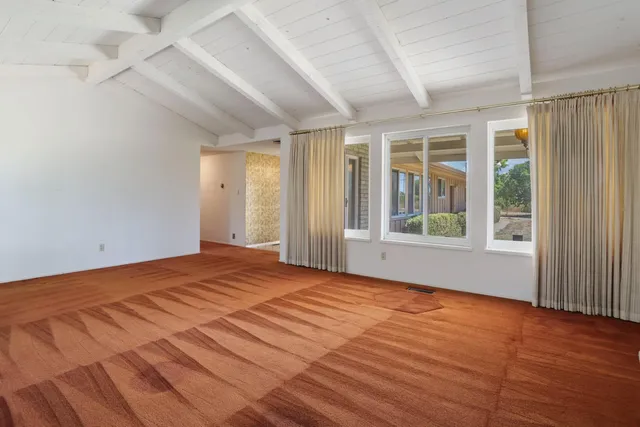a view of an empty room with a fireplace