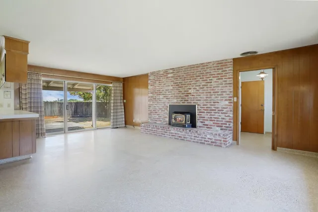 a view of a kitchen with furniture and a fireplace