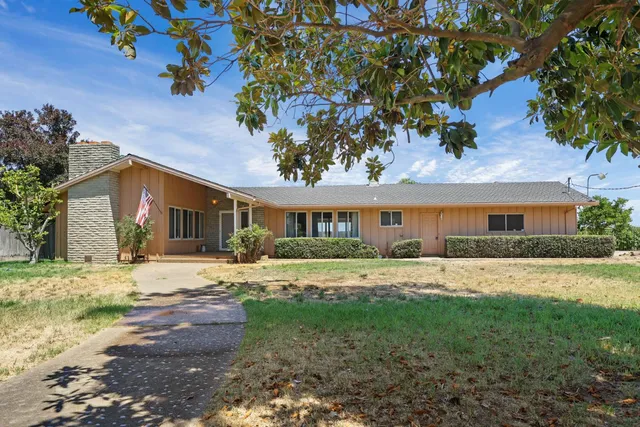 a front view of house with yard and green space