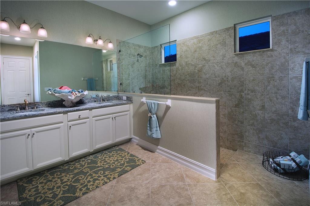 14731 Nautilus Place Naples, FL 34114 - Photo 20 of 22 a bathroom with a sink a vanity and a mirror