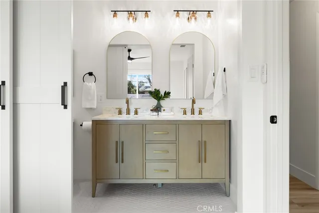a bathroom with a double vanity sink toilet and shower
