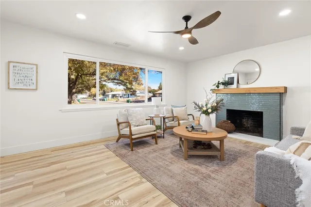 a living room with furniture a window and a fireplace