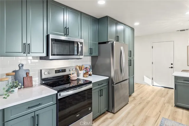 a kitchen with a refrigerator stove and microwave