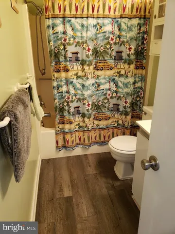 a bathroom with a toilet and a shower curtain