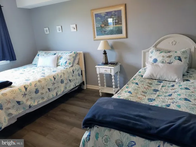 a bedroom with bed and wooden floor