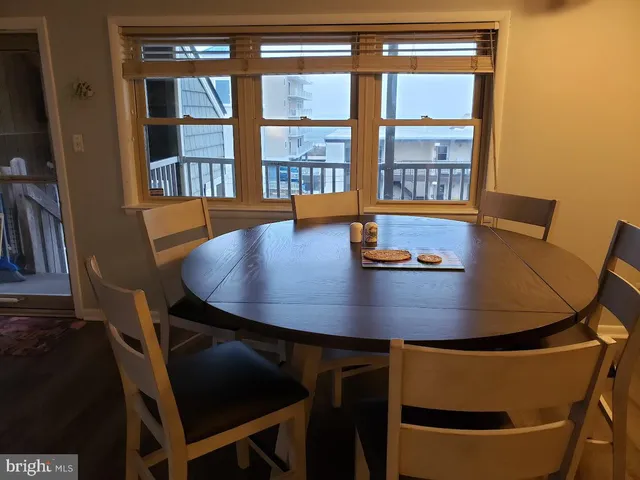a view of a dining room with furniture and a window