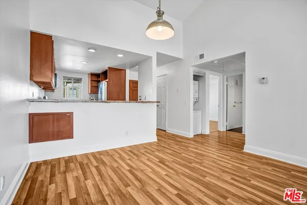 a view of a kitchen with wooden floor and a sink
