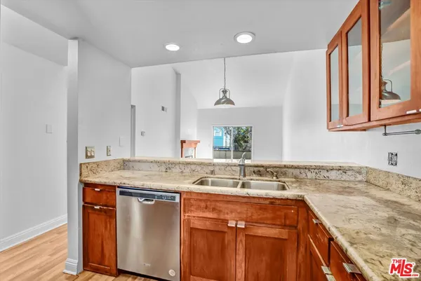 a kitchen with stainless steel appliances granite countertop a sink stove and cabinets
