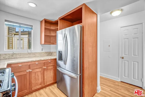 a kitchen with stainless steel appliances granite countertop a refrigerator and a sink