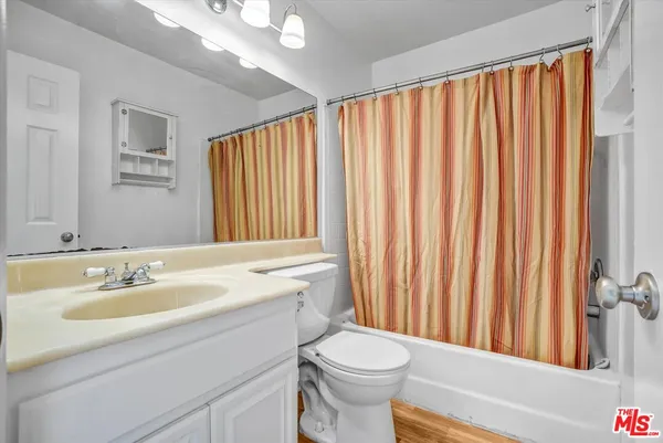 a bathroom with a sink a toilet and tub