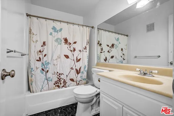 a bathroom with a sink a toilet and a bathtub