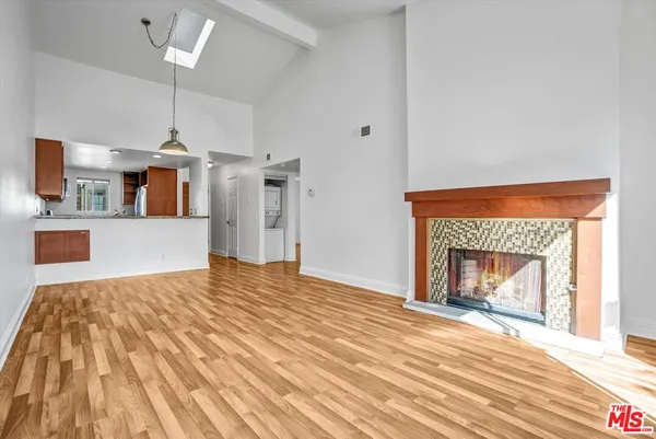 a view of a kitchen with a fireplace and wooden floor