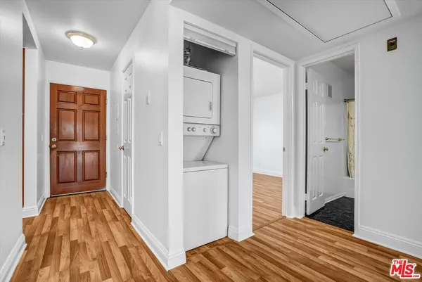 a view of a bedroom with wooden floor and bedroom space