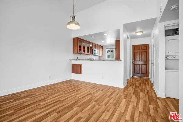 a view of a room with wooden floor and a ceiling fan