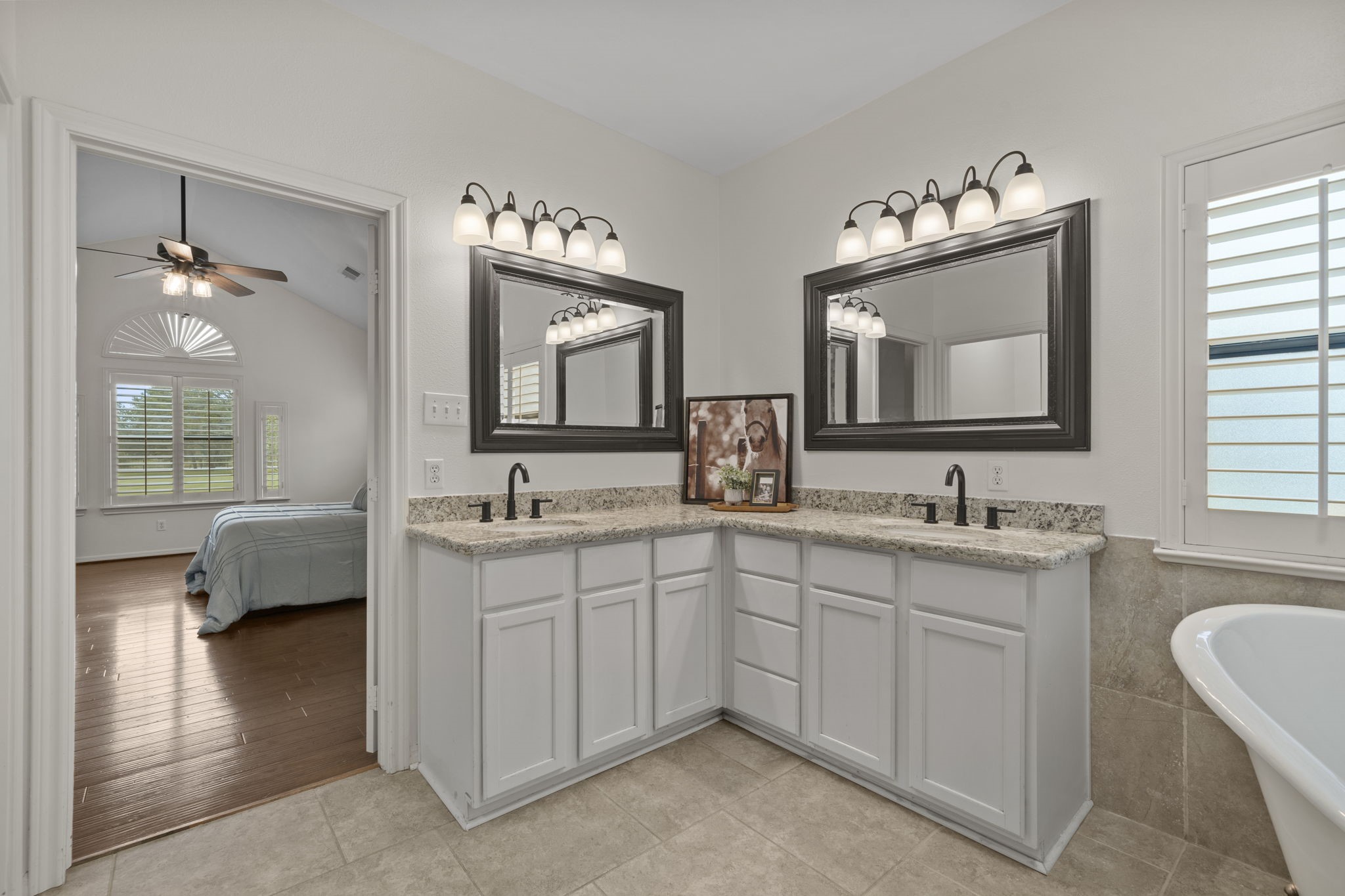 26435 Clay Road Katy, TX 77493 - Photo 21 of 50 a en suite bathroom with double vanity sinks a large mirror and a window