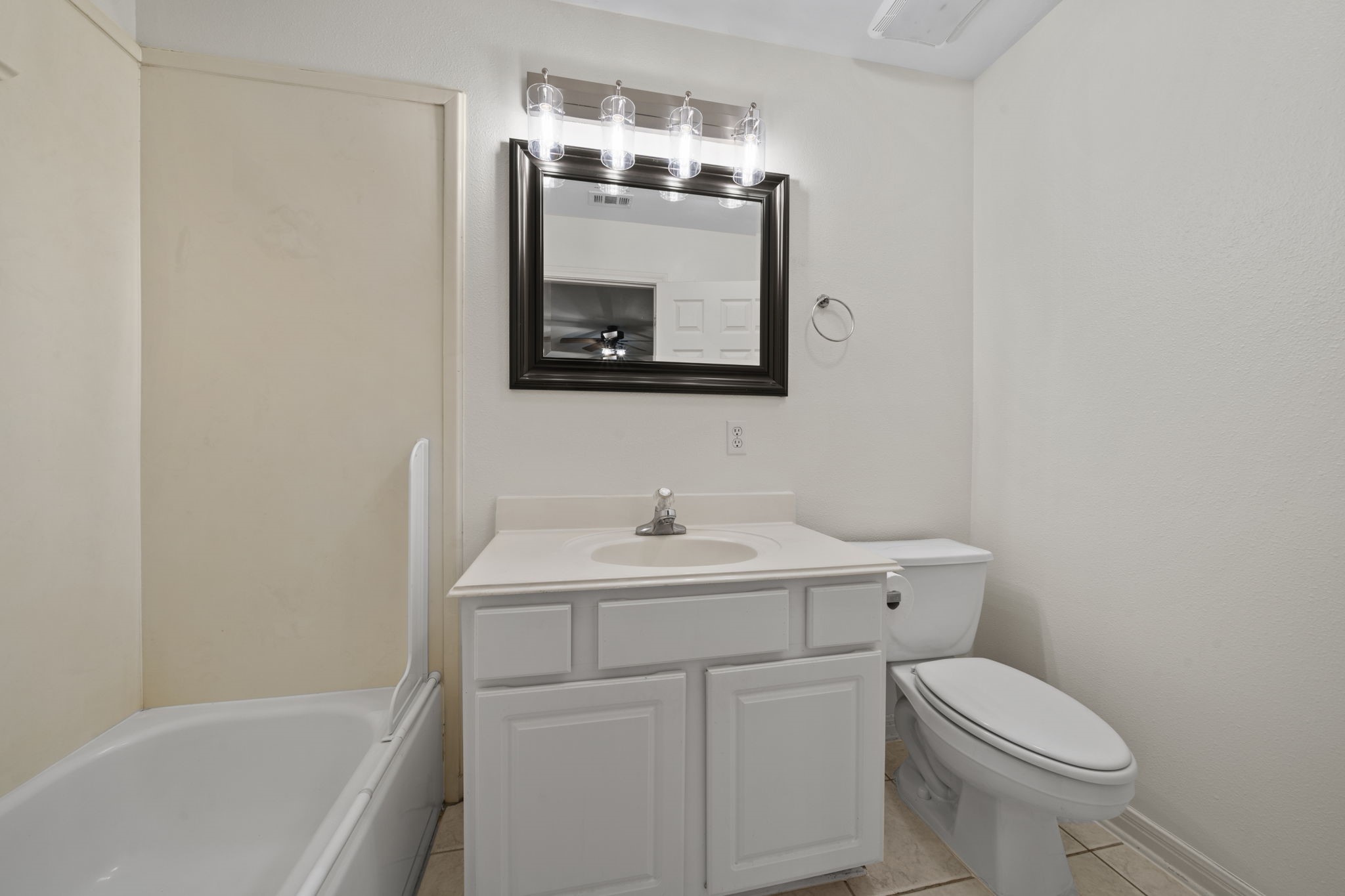 26435 Clay Road Katy, TX 77493 - Photo 26 of 50 a bathroom with a toilet sink and mirror