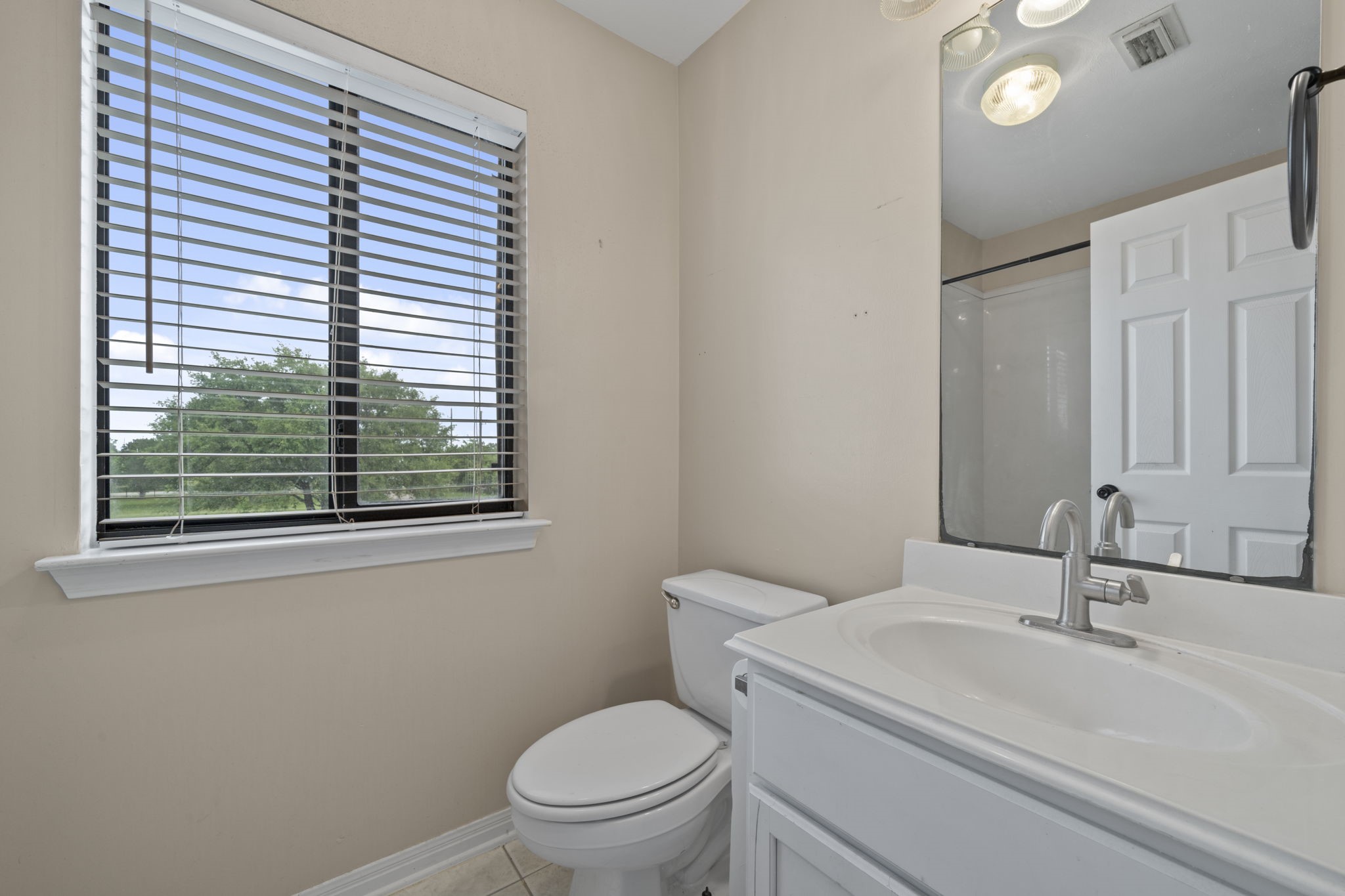 26435 Clay Road Katy, TX 77493 - Photo 29 of 50 a bathroom with a sink a toilet and a window
