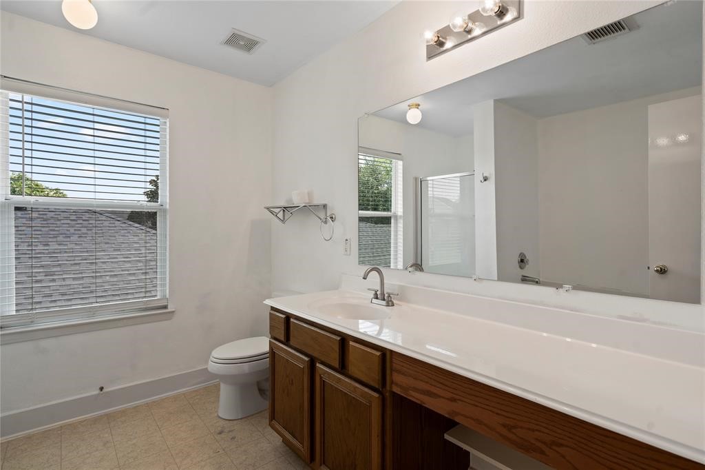 20729 Patriot Park Lane Katy, TX 77449 - Photo 22 of 39 a bathroom with a sink mirror and toilet